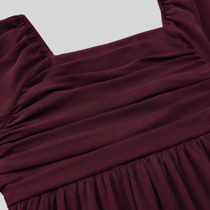 Long sleeve mini dress with square neckline, pleated bodice, defined waist, and flowy fit-and-flare silhouette