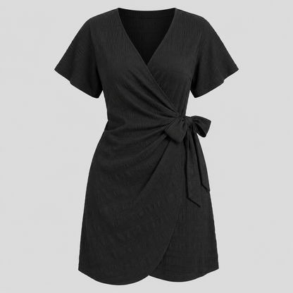 Short sleeve wrap mini dress with surplice V-neckline, side tie waist, and textured fabric