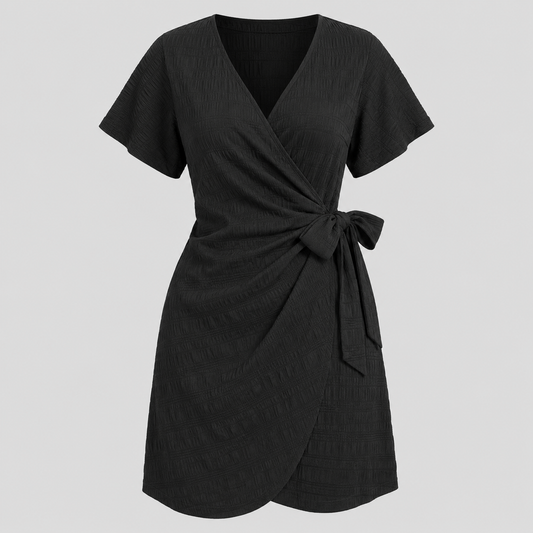 Short sleeve wrap mini dress with surplice V-neckline, side tie waist, and textured fabric