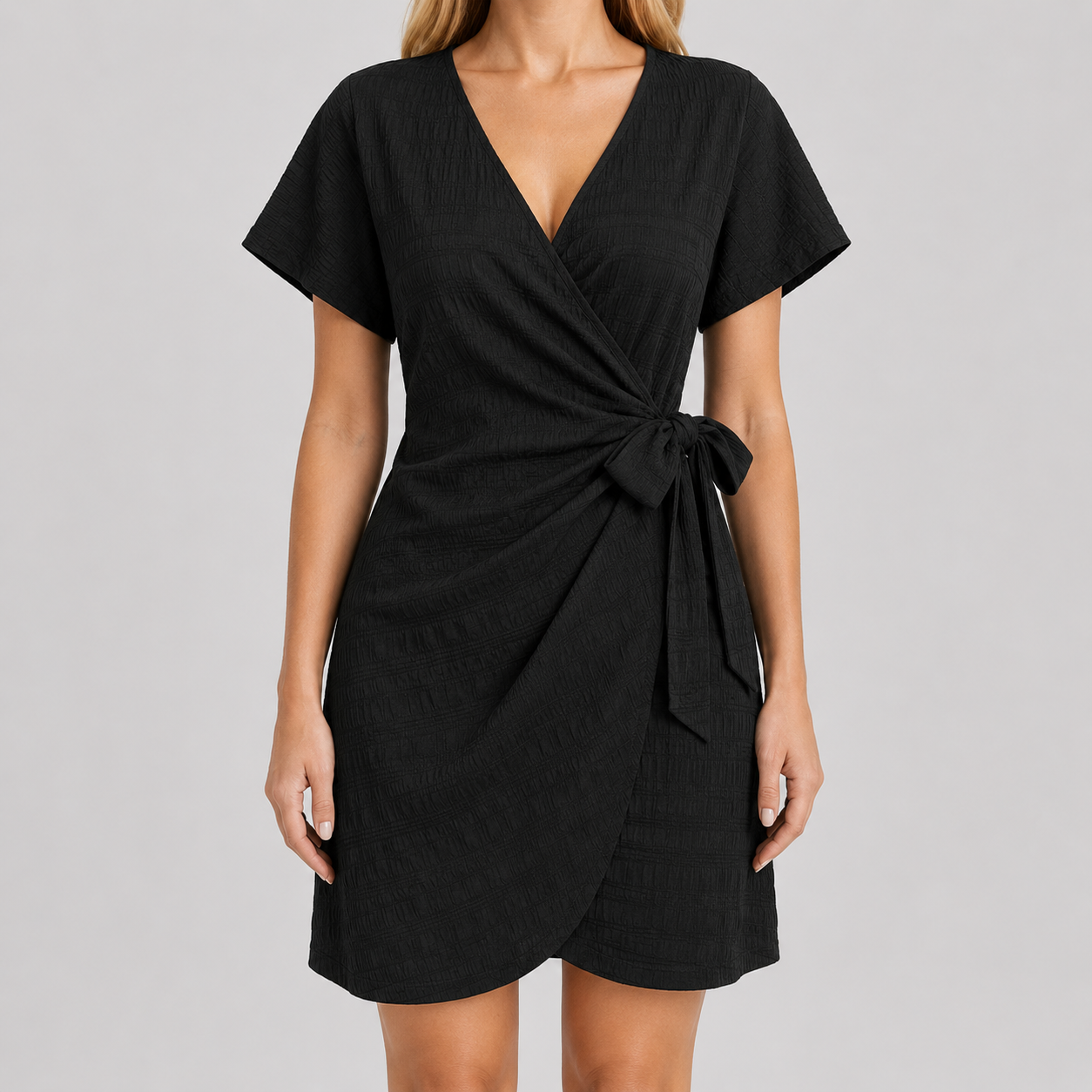 Short sleeve wrap mini dress with surplice V-neckline, side tie waist, and textured fabric